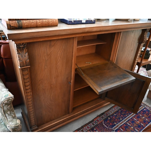 513 - Contemporary heavy quality Flemish oak side cabinet with central carved panel doors flanked by long ... 