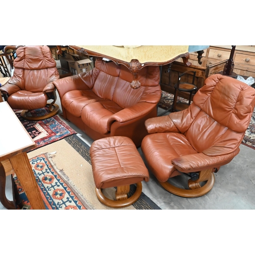 516 - An Ekornes Stressless tan leather suite comprising two seater sofa, pair of reclining armchairs and ... 