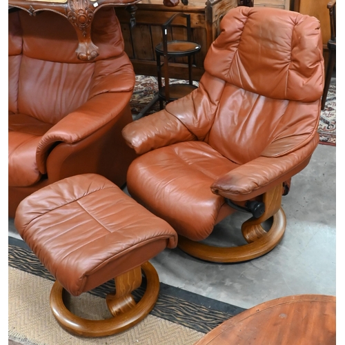 516 - An Ekornes Stressless tan leather suite comprising two seater sofa, pair of reclining armchairs and ... 