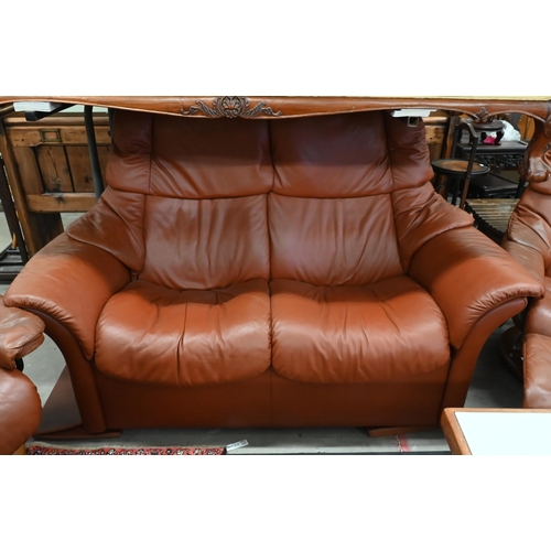 516 - An Ekornes Stressless tan leather suite comprising two seater sofa, pair of reclining armchairs and ... 