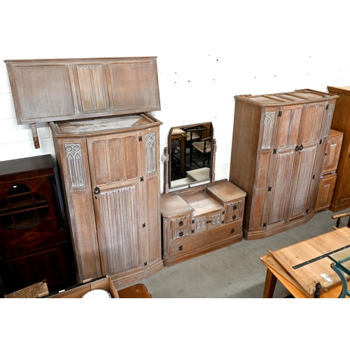 290 - A 'Crown Ay' limed oak bedroom suite with carved gothic arch and linenfold panels comprising double ... 