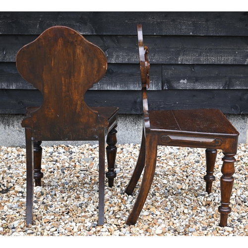 210 - A pair of Victorian armorial carved oak hall chairs with panelled seats and turned front legs (2)