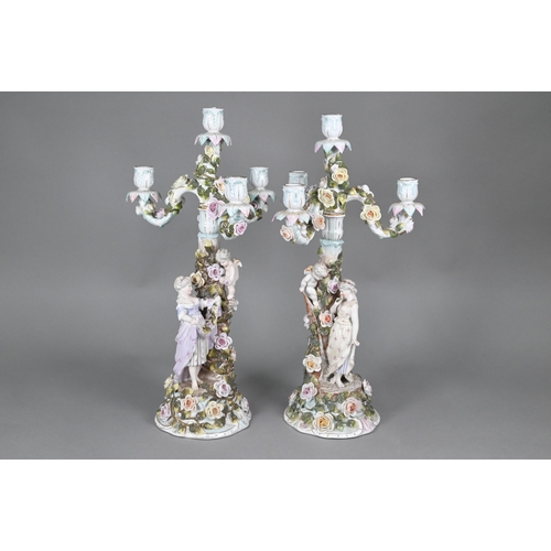 61 - A pair of Sitzendorf porcelain floral-encrusted candelabra with detachable three branch tops, the ba... 