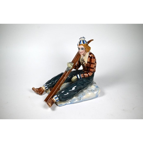 63 - Nove (Venice) pottery figure of a lady skier, seated on the snow and holding her skis, modelled by B... 