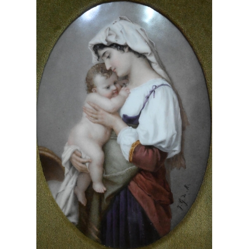 66 - A 19th century porcelain oval plaque, painted with a mother and child, signed F.G. de M, impressed '... 