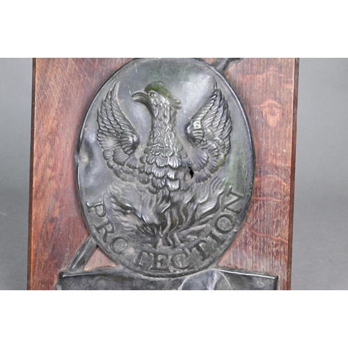 191 - A 19th century tin insurance plaque embossed with phoenix over 'Protection', on oak plaque 31 x 22 c... 