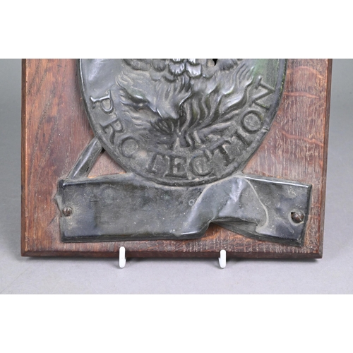 191 - A 19th century tin insurance plaque embossed with phoenix over 'Protection', on oak plaque 31 x 22 c... 