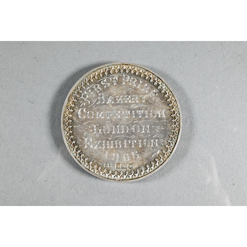 521 - An Edwardian silver medal 'First Prize Bakery Competition London Exhibition 1905', 'Presented by the... 