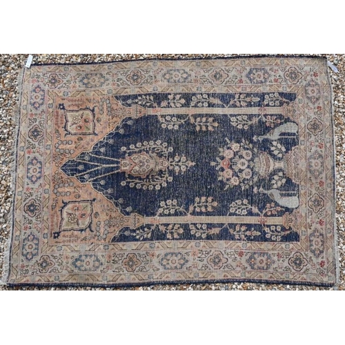 152 - An antique Persian hand-made Kashan rug, the washed camel field centred with a blue medallion, 195 c... 