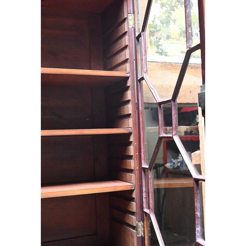 399 - A George III mahogany secretaire library bookcase, the pair of astragal glazed cabinet doors enclosi... 