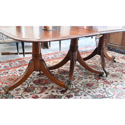 131 - A 19th century mahogany extending dining table, the rounded rectangular top in three sections on tri... 