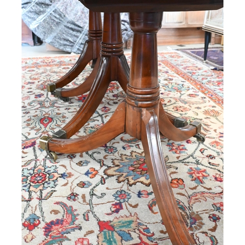 131 - A 19th century mahogany extending dining table, the rounded rectangular top in three sections on tri... 