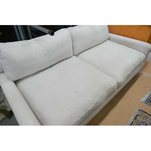 134 - A Loaf Banoffee sofa, cream woven linen upholstery and turned light oak tapering legs, 210 cm w x 10... 