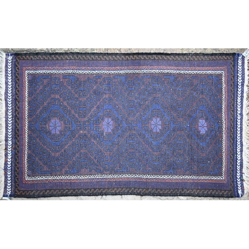 145 - Persian Baluchi rug, geometric design in brown on indigo ground, narrow borders and kelim ends, 158 ... 