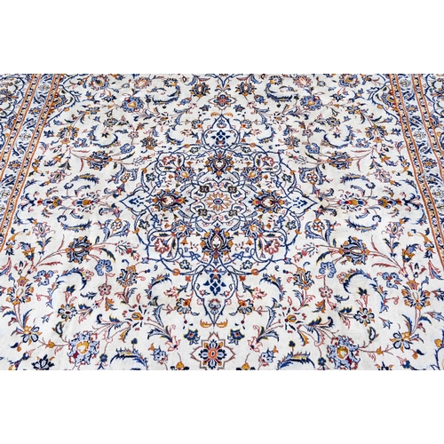 146 - Large Persian Kashan carpet, traditional scrolling floral design on cream ground within palmette bor... 