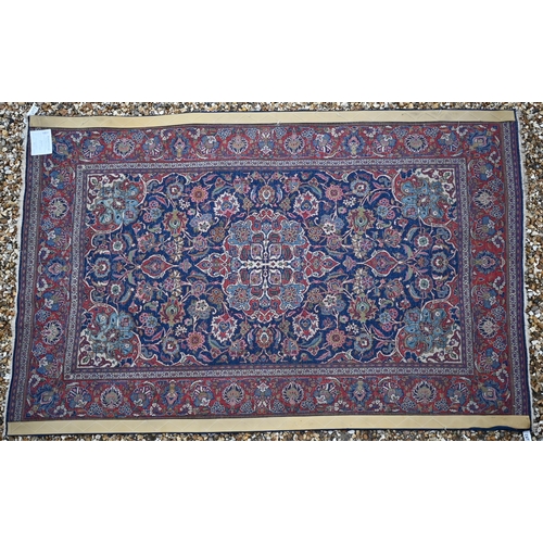 150 - A Persian Kashan rug, palmettes and rosettes arranged symmetrically around the large central floral ... 