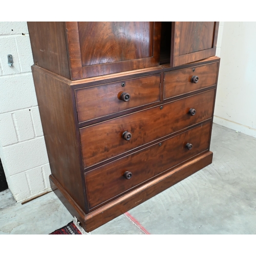 157 - A 19th century mahogany wardrobe (converted from a linen press) with panelled doors enclosing hangin... 