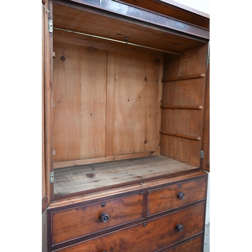 157 - A 19th century mahogany wardrobe (converted from a linen press) with panelled doors enclosing hangin... 