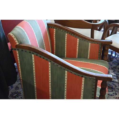 161 - An early 20th century oak framed armchair with green and red striped fabric uphostery