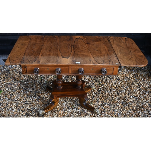 168 - A Regency rosewood sofa table (damaged leaf) with two drawers and concaved platform base with splaye... 