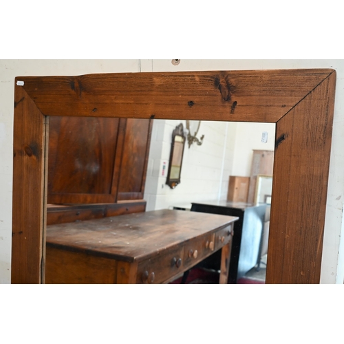 171 - A large rectangular wall mirror in stained pine frame, 140 cm x 80 cm 