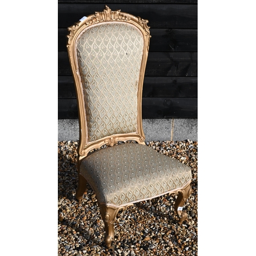 173 - A Continental gilt framed nursing chair with repeating leaf pattern brocade upholstery