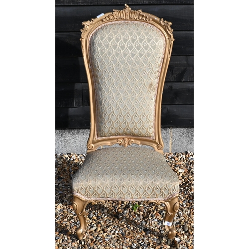 173 - A Continental gilt framed nursing chair with repeating leaf pattern brocade upholstery