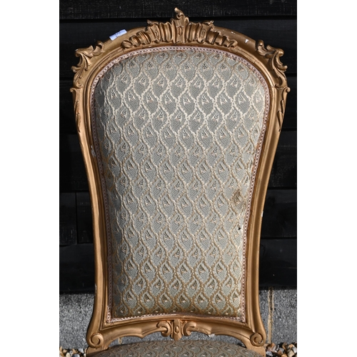 173 - A Continental gilt framed nursing chair with repeating leaf pattern brocade upholstery