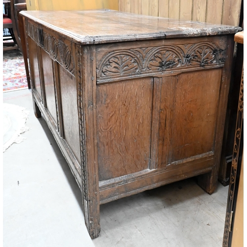 204 - An antique carved and panelled oak coffer, 132 cm wide x 58 cm deep x 72 cm high