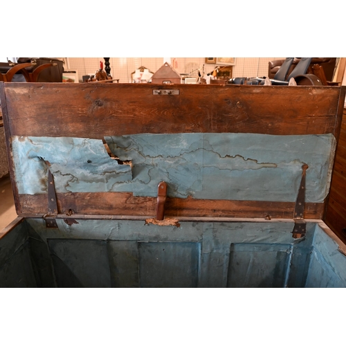 213 - A large antique panelled oak coffer, hinged top enclosing the deep storage area, 138 cm wide x 56 cm... 