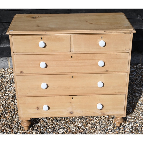 217 - A waxed pine chest of two short over three long drawers with white crackle-glazed ceramic handles st... 