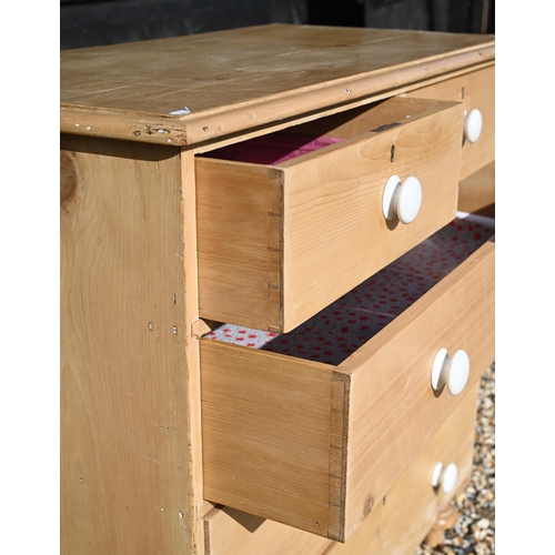 217 - A waxed pine chest of two short over three long drawers with white crackle-glazed ceramic handles st... 