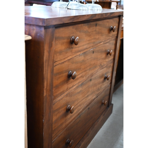 218 - A large Victorian mahogany chest of four long graduating drawers with turned handles, raised on plin... 