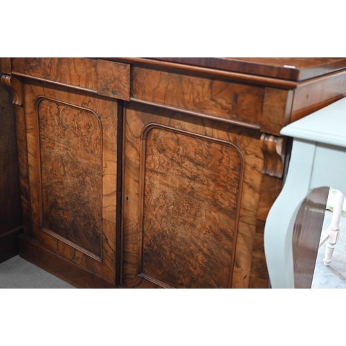 220 - A Victorian burr walnut chiffonier with two drawers over arched platform cupboard doors raised on pl... 