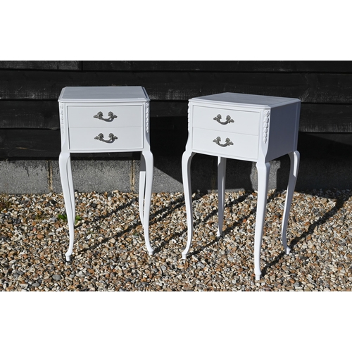 223 - A pair of white painted French bedside tables with floral carved decoration and slender cabriole sup... 