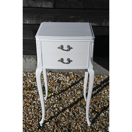 223 - A pair of white painted French bedside tables with floral carved decoration and slender cabriole sup... 