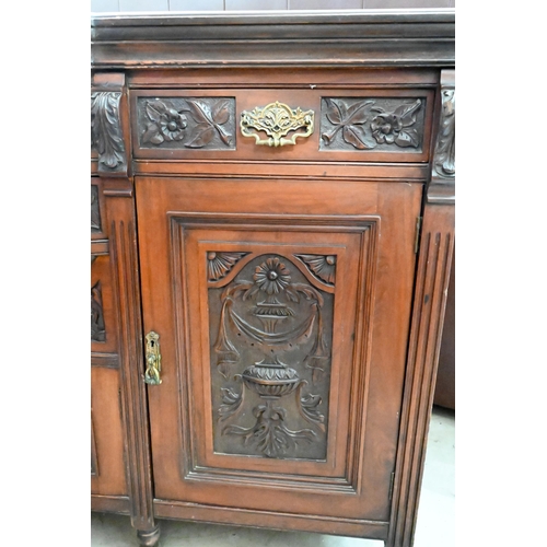 239 - A large late Victorian mahogany sideboard with floral and foliate carved door panels and drawer fron... 