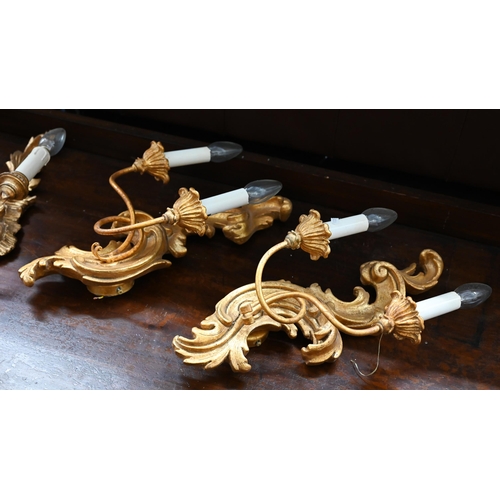 240 - A trio of rococo style giltwood twin branch wall sconces, 60 cm high to/w pair of somewhat similar e... 