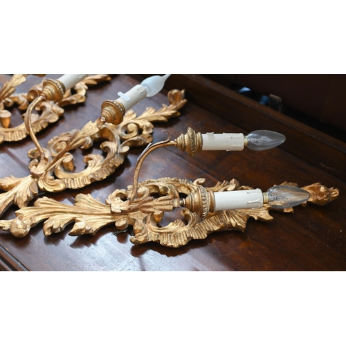 240 - A trio of rococo style giltwood twin branch wall sconces, 60 cm high to/w pair of somewhat similar e... 