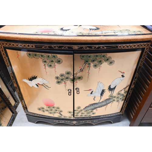 244 - A Japanese gilt and black lacquered two door cabinet decorated with red crowned cranes (Tswu), 82 cm... 