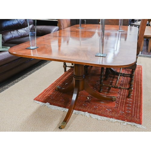 250 - A Regency style mahogany dining table with cross banded ebony strung top on twin-pedestal supports w... 