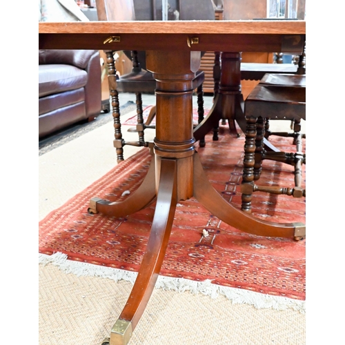 250 - A Regency style mahogany dining table with cross banded ebony strung top on twin-pedestal supports w... 