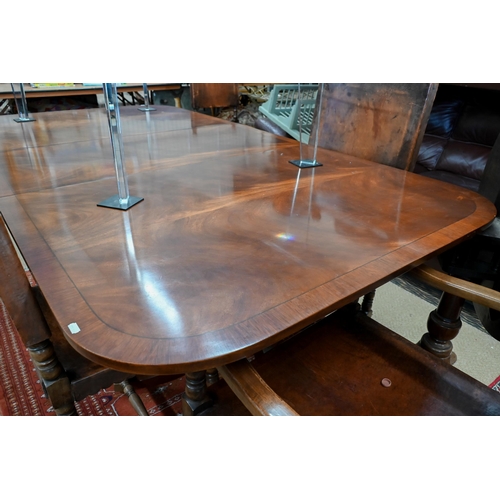 250 - A Regency style mahogany dining table with cross banded ebony strung top on twin-pedestal supports w... 