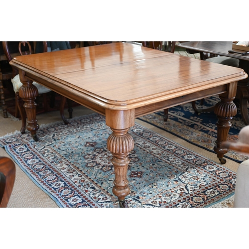 257 - A late Victorian mahogany extending dining table, the moulded rectangular top winding out to accept ... 