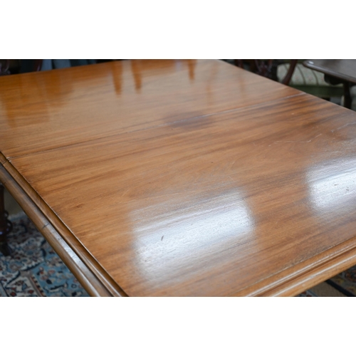 257 - A late Victorian mahogany extending dining table, the moulded rectangular top winding out to accept ... 