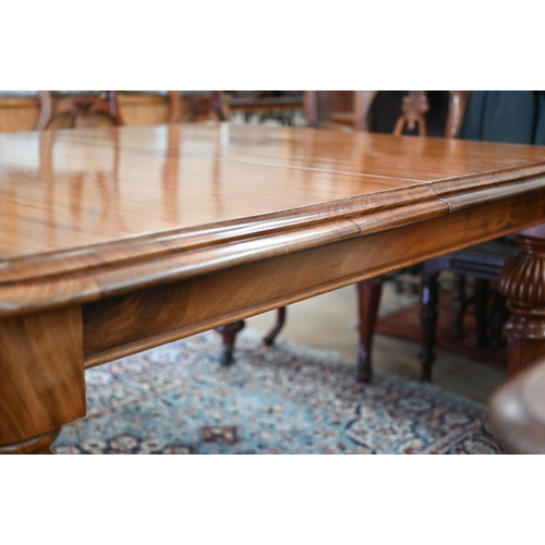 257 - A late Victorian mahogany extending dining table, the moulded rectangular top winding out to accept ... 