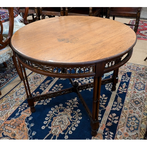 259 - An Edwardian mahogany circular table with fret cut frieze and cross-stretchers on simulated bamboo s... 