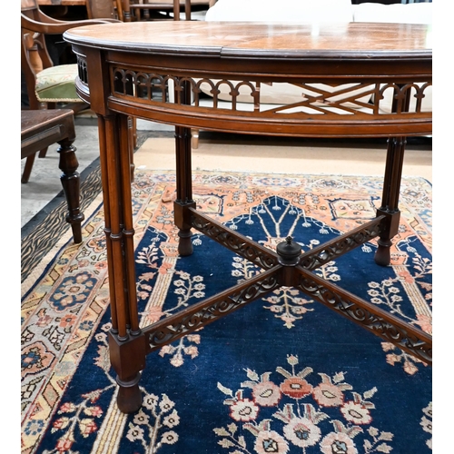 259 - An Edwardian mahogany circular table with fret cut frieze and cross-stretchers on simulated bamboo s... 