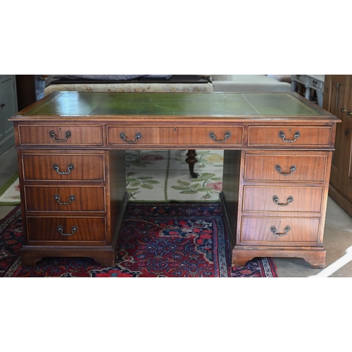 265 - A large reproduction mahogany twin-pedestal desk with gilt-tooled green leather top over eight drawe... 