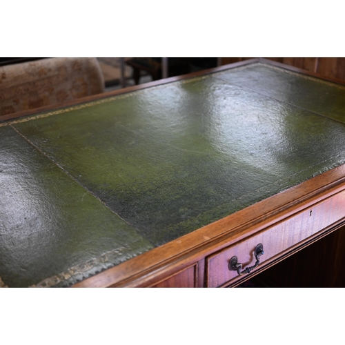 265 - A large reproduction mahogany twin-pedestal desk with gilt-tooled green leather top over eight drawe... 